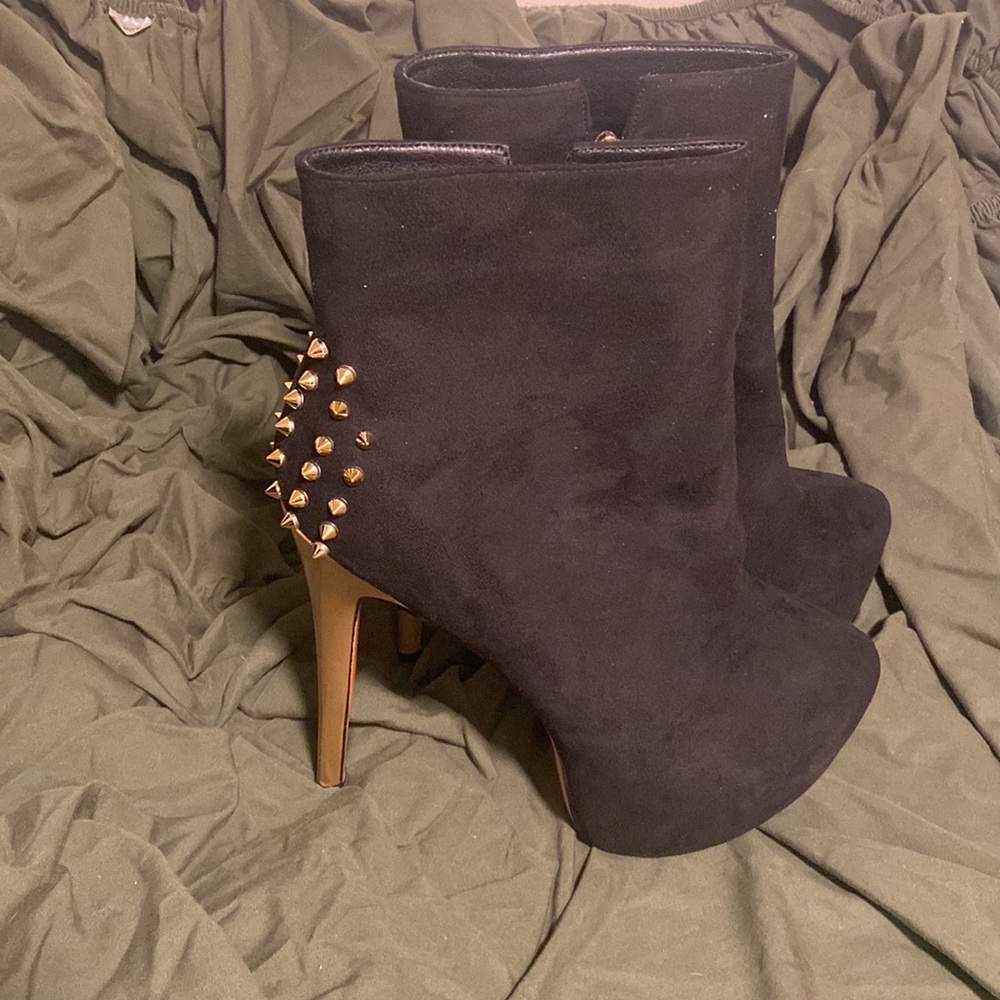 Black heels with gold spiked heel.